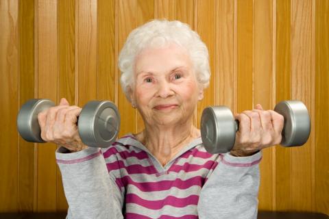 Older woman who uses small weights to exercise her arms