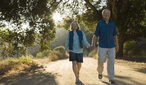 A couple of older people walking outdoors