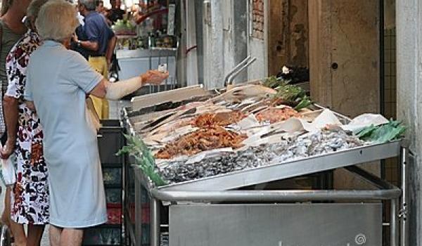 Older women at the market, in front of the fish stall