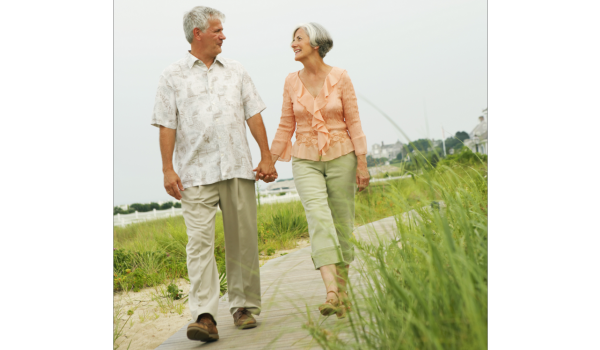 A couple of older people walking outdoors